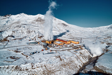Aerial view to geothermal power plant in mountain. Clean renewable green energy in Kamchatka.