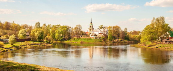 Russian province. Bell tower on the lake shore