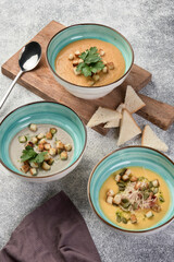 cream soups from pumpkin, lentils, mushrooms on a light gray background top view