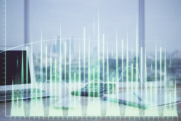 Forex Chart hologram on table with computer background. Multi exposure. Concept of financial markets.