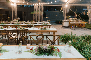 Wedding reception night dinner setup table with beautiful flower decoration.