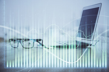 Forex Chart hologram on table with computer background. Multi exposure. Concept of financial markets.