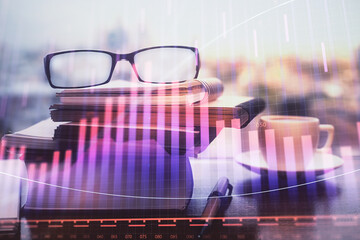 Financial graph hologram with glasses on the table background. Concept of business. Double exposure.