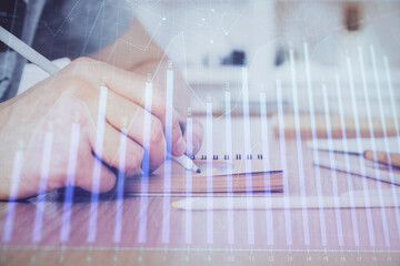 Multi exposure closeup hands with stock market forex graph.