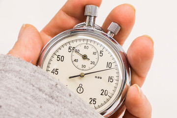 Old antiquary timer clock and humans hand
