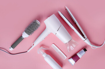 Various hairdresser's tools on a pink background with copy space. Hairdressing set with various...