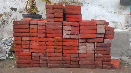 a pile of old red brick for build a house in urban area