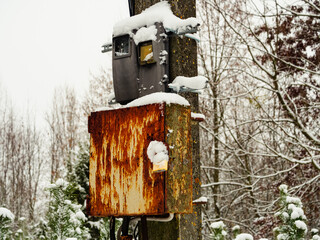 Electric transformer box in the park on a pole closed with a padlock