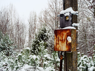 Electrical junction box in the park on a pole closed with a padlock