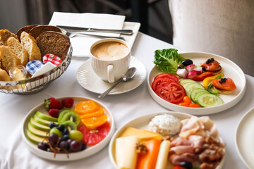 Luxury hotel and five star room service, various food platters, bread and coffee as in-room breakfast for travel and hospitality brand