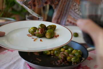 Pouring Brussels sprouts in a plate