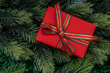 Christmas tree branches and christmas gift. Christmas concept, nature, winter. Background for postcards. Flat lay, top view