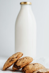 Homemade cookies with chocolate on the background of a bottle of milk