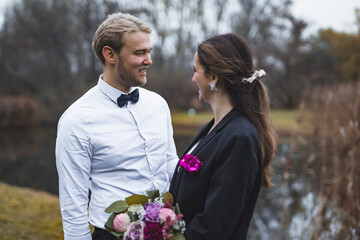 Young happy married man and woman on their wedding day outdoor in nature. High quality photo