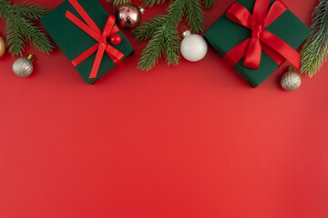 Christmas composition. Festive decor on red background. Copy space, flat lay, top view.