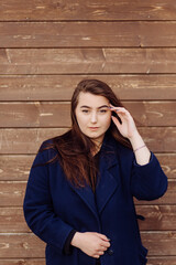 Beautiful Young Stylish Girl in wood background