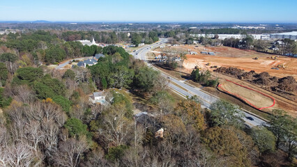 Residential neighborhood with small church near large construction project with raft foundation...