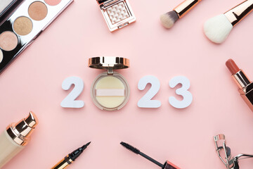 2023 Beauty cosmetic makeup products trends concept. Top view of 2023 white number with powder,...