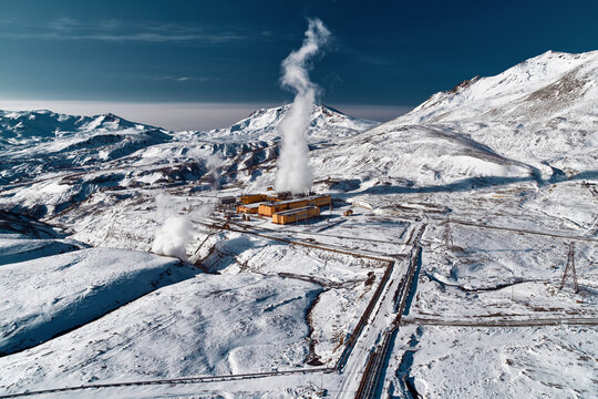 Aerial view to geothermal power plant in mountain. Clean green renewable energy in Kamchatka.