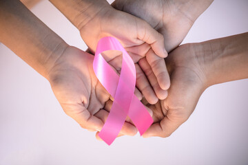 Family hand holding pink ribbon. concept healthcare and medicine, cancer concept