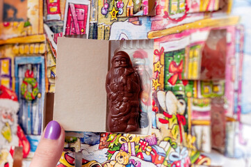 Santa Claus Christmas advent calendar chocolate in a box, girl opening a choco gift