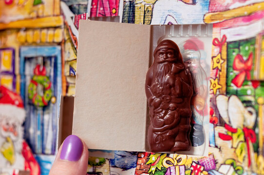 Santa Claus Christmas advent calendar chocolate in a box, girl opening a choco gift