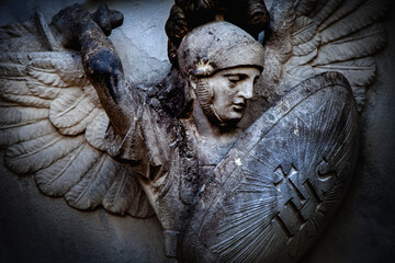 Saint Michael struggles with evil. Fragment of antique statue. Good triumphs over evil concept. Close up.
