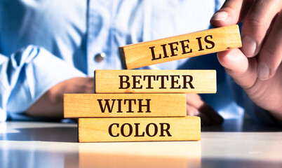 Wooden blocks with words 'Life is Better With Color'.