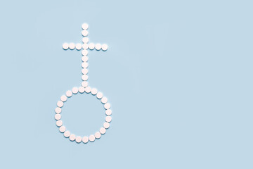 Medical pills in female symbol shape on a light blue background. Concept female  health,...