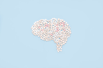 Brain made of pills on blue background. Multiple sclerosis awareness, mental health , dementia, epilepsy,  medical diagnosis
