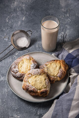 Patties with cottage cheese on a marble table. Russian pastry (vatrushka)
