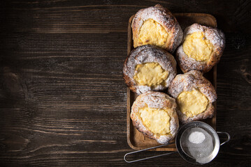 Patties with cottage cheese on a wooden table. Russian pastry (vatrushka)
