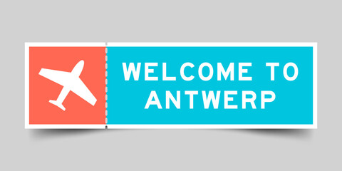 Orange and blue color ticket with plane icon and word welcome to antwerp on gray background