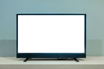 Flat LCD television on wood table in the living room with dark gray wall