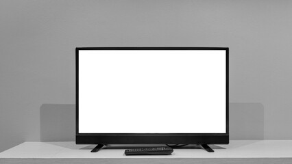 Flat LCD television on wood table in the living room with dark gray wall