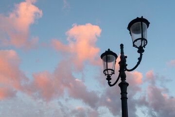 Street lantern against dusk sky with pink clouds.
