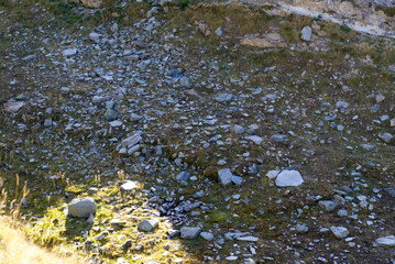 Scenic view of famous Swiss mountain pass Furkapass with rocks and mountain peak on a sunny late summer day. Photo taken September 12th, 2022, Furka Pass, Switzerland.