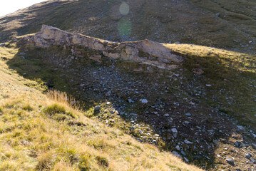 Scenic view of famous Swiss mountain pass Furkapass with rocks and mountain peak on a sunny late summer day. Photo taken September 12th, 2022, Furka Pass, Switzerland.