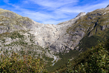 View of famous Rhone Glacier with Rhone River in the Swiss Alps with glacier river on a sunny late summer day. Photo taken September 12th, 2022, Furka Pass, Switzerland.