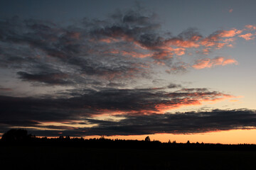 Orange sunset with different shaped clouds.