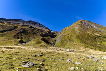 Scenic view of famous Swiss mountain pass Furkapass with rocks and mountain peak on a sunny late summer day. Photo taken September 12th, 2022, Furka Pass, Switzerland.