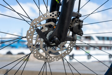 Bicycle front hydraulic brake and sprocket, metal, steel, blurred background