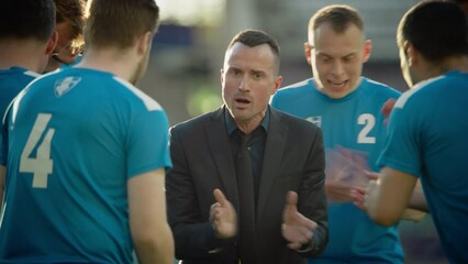 Professional Football Team Training, Tactical Coaching: Soccer Manager Explains Game Strategy, Workout Plan. Trainer Motivates Athletes, Lead to Victory, Preparing For Championship. Medium Static Shot - Powered by Adobe