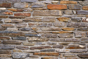 Close-up of stone wall pattern on a sunny late summer morning at Swiss mountain village Realp, Canton Uri. Photo taken September 12th, 2022, Realp, Switzerland.