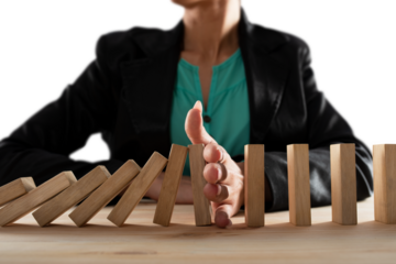 businesswoman stops with hand the falling chain like a domino game