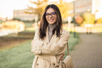 Independent young woman 20-30s wearing glasses with hands crossed in the street