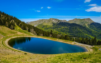 Naklejka na ściany i meble Mourtis, France - May 20th 2021: The small pond near the summit of Tuc de l'Étang near Mourtis ski resort, a peak in the Pyrenees Mountains range in the south of France