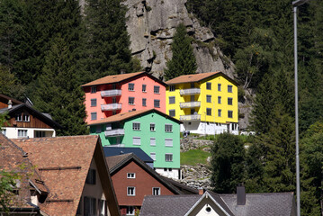 Fototapeta na wymiar Mountain village Göschenen with beautiful colored houses on a sunny late summer day. Photo taken September 12th, 2022, Göschenen, Switzerland.