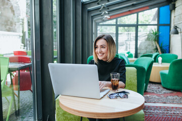 businesswoman with smart phone and notebook in coffee shop