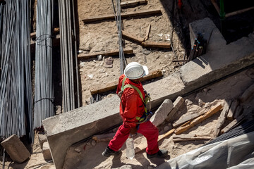 Worker on skyscraper construction. Modern arab city architecture